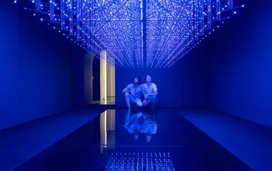 two men admire a blue light installation at the White Rabbit Gallery in Sydney
